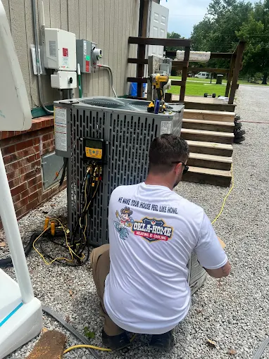 Okla-Home technician servicing air conditioning system