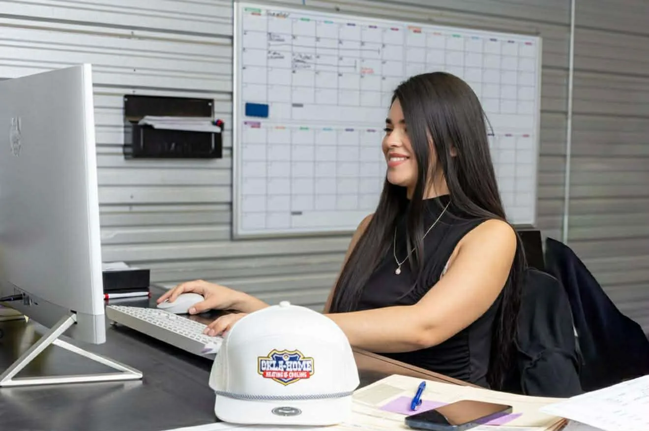 Okla-Home Heating & Cooling office receptionist ready to schedule your HVAC service